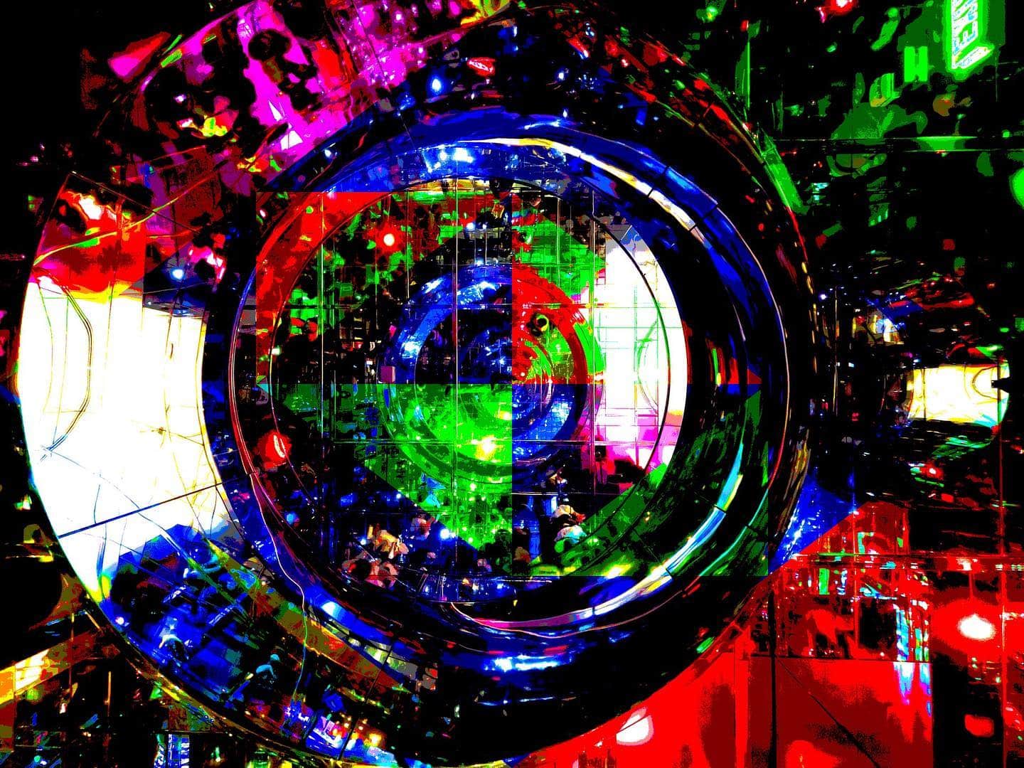 Composición digital circular con reflejos y colores primarios sobre fondo negro.